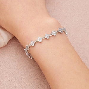Bracelet trèfle élégant en argent avec pavé de zircons blancs sur fond rose doux