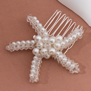 Elegant starfish hair comb with pearls and crystals for bridal hairstyles on brown fabric
