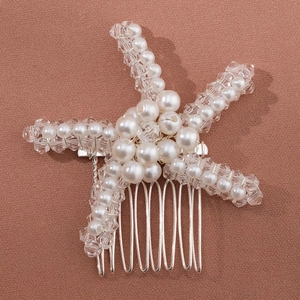 Detail of handmade bridal starfish hair comb with pearls and crystals on silver wire