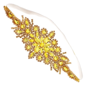 Detailed view of yellow crystal rhinestones on elastic headband with geometric design