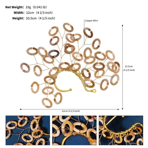 Detailed macro view of handmade copper wire bridal ear cuff with resin floral rings