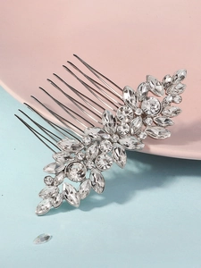 Macro detail of bridal hair comb featuring silver alloy leaves and crystal rhinestones