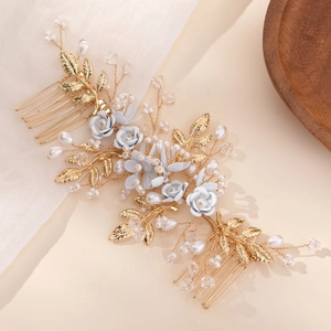 Handmade bridal hair combs with gold leaves and blue flowers for elegant wedding styling