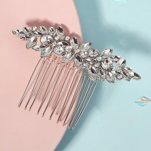 Silver bridal hair comb with marquise crystals and leaf design on pastel background