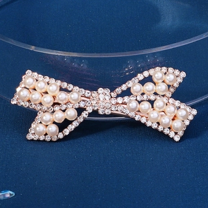 Elegant gold bow hair clip with white pearls and sparkling rhinestones for women
