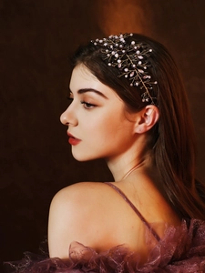Detail showing vintage bridal hair comb with purple crystals and gold wire branch