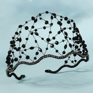 Macro detail of gothic style black crystal beads and sparkling rhinestone headband trim