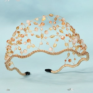 Detailed macro view of handmade gold wire mesh headband with amber faceted crystal beads