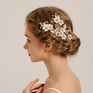 Vintage bridal hair comb set with golden leaves and white flowers for wedding styling