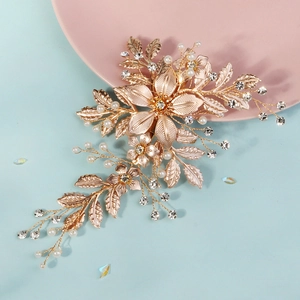 Luxurious rose gold bridal hair clip with pearls, rhinestones and floral leaf design