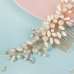Macro detail of handmade bridal hair comb with gold wire, pearls and crystals