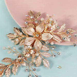 Luxurious gold metal bridal hair clip with floral leaves, pearls and crystals decoration