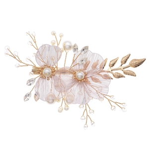 Handmade bridal hair clip with gold flowers, pearls and crystals on a white background
