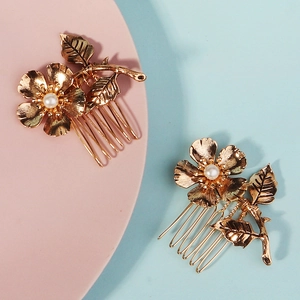 Elegant pair of gold floral hair combs with pearls and leaf accents on 5-tooth metal combs