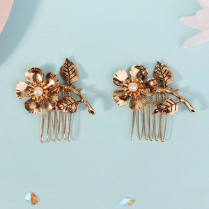 Detail showing vintage gold flower hair combs with white pearls and textured metal leaves