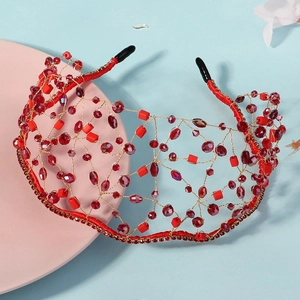 Detailed view of handmade bridal headband with red beads and golden mesh wire weave