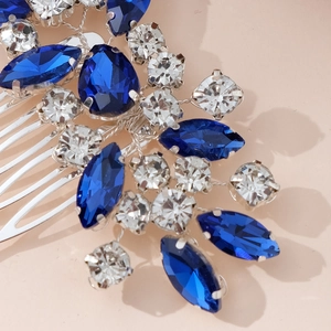 Macro shot of navy blue and clear rhinestones on a silver bridal hair comb detail