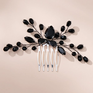 Detailed close-up of retro black crystal beads on silver metal bridal hair comb