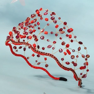 Detailed close-up of handmade red crystal mesh headband with gold wire and red beads
