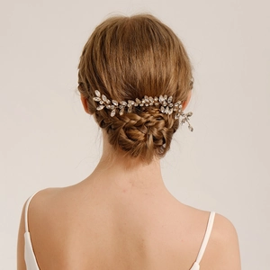 Elegant gold bridal hair comb with crystal leaves and rhinestones for wedding hairstyles