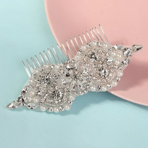 Detailed view of silver bridal hair comb with hand-set rhinestones and white pearls