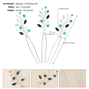 Detailed view of silver branch hair pins with green crystals and white pearls