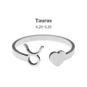 Macro shot of silver Taurus zodiac ring featuring a heart symbol and polished finish