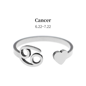 Detail of silver Cancer zodiac sign open ring featuring heart accent and Cancer text