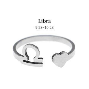 Detail view of silver Libra zodiac ring featuring a heart symbol and adjustable opening