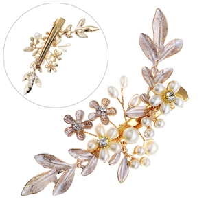 Golden floral bridal hair clip with faux pearls and rhinestones on a clean white background