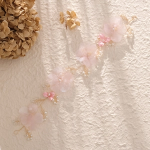 Macro shot of handmade floral headband with pink mesh flowers and white pearls