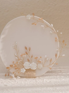 Detailed shot of handmade bridal hair comb with white resin roses and crystal beads