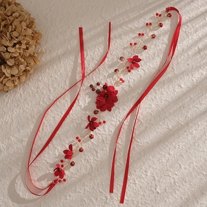 Handmade red flower bridal headband with gold accents and silk ribbons for weddings