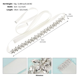 Close-up of sparkling rhinestone flower patterns on a white bridal satin sash belt