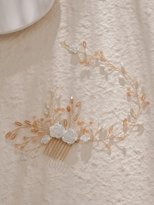 Detailed view of handmade bridal hair comb with resin roses, pearls and crystals