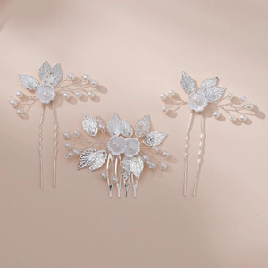 Detail of silver leaf bridal hair pin and comb set with pearls and white flowers