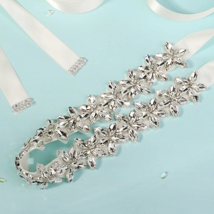 Detailed close-up of bridal rhinestone belt with marquise crystals on white satin ribbon