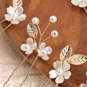 Handmade bridal hair pins set with gold leaves and resin flowers for classic styling