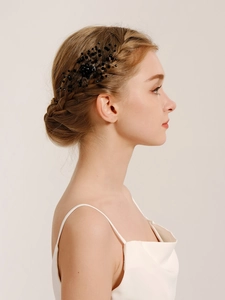 Detailed view of handmade black crystal bead hair comb styled in a French braid