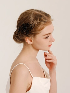 Detail of handcrafted black crystal hair comb accessory on elegant bridal updo