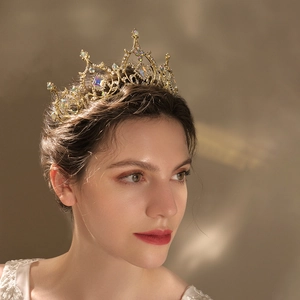 Detailed side view of golden baroque crown with colorful crystals on model