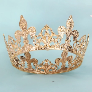 Detailed close-up of golden crown featuring fleur-de-lis cutouts and sparkling rhinestones