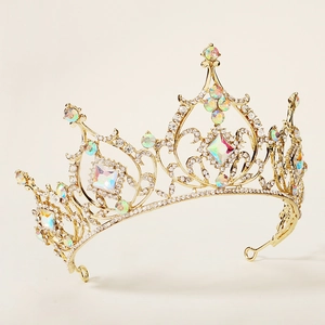 Detailed macro view of the golden alloy tiara showing intricate hollow patterns and AB rhinestones