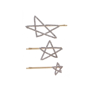 Three-piece set of gold star hair clips with white rhinestones on a white background