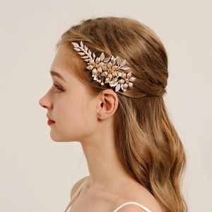Elegant gold leaf and flower bridal hair clip with pearls for wedding hairstyles