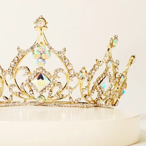 Close-up of golden luxury tiara with shimmering colorful crystals and white diamonds
