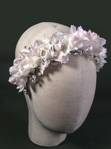 Detail showing pink fabric flowers and crystal beads on a bridal hair hoop