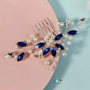 Détail d'un peigne à cheveux de mariée argenté avec strass bleus et perles blanches
