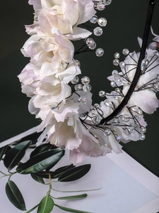 Detail of handmade floral headband with silk petals and sparkling crystal beads