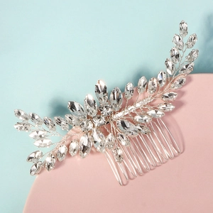 Detailed view of silver wedding hair comb with marquise rhinestones on a blue background